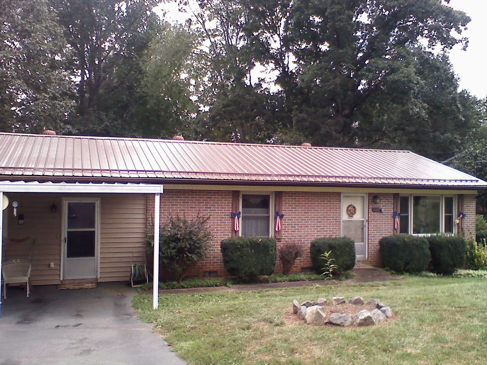 Bronze metal roof and carport on a brick ranch home — Roof Repair work by our crew in Dresden